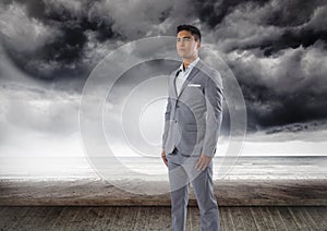 Businessman standing by dark sea