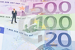 Businessman standing on the Euro banknote