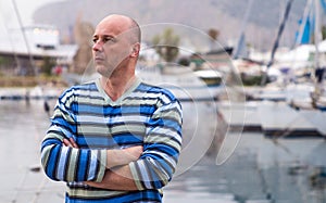 Businessman standing by expensive sailing boats and yachts in a