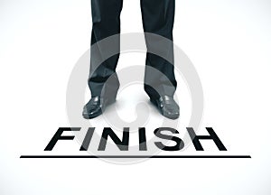 Businessman standing on a finish line