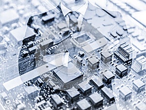 Businessman standing with folded arms in a classic navy blue suit against pc motherboard chip photo layer.