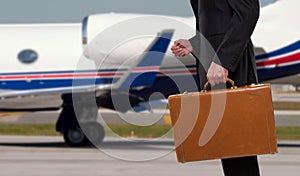 Businessman standing in front of corporate jet