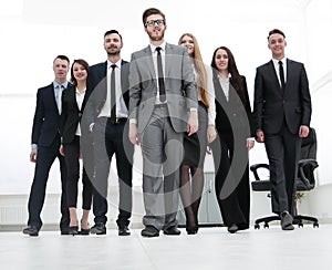 Businessman standing in front of her business team