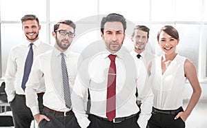 Businessman standing in front of his business team