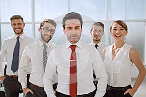 Businessman standing in front of his business team