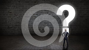 Businessman standing in front of a portal shaped as a questionmark photo