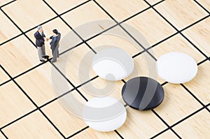 Businessman standing on the Go board game, Business st