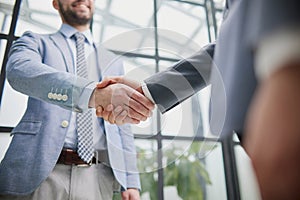 businessman standing greeting partner with handshake. Leadership, trust, partnership concept.