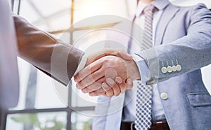 businessman standing greeting partner with handshake. Leadership, trust, partnership concept.