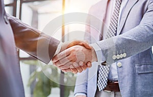 businessman standing greeting partner with handshake. Leadership, trust, partnership concept.
