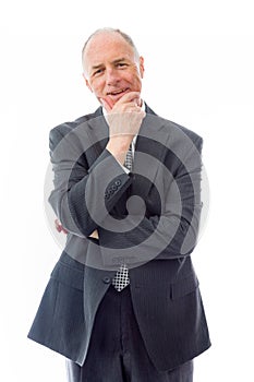 Businessman standing with hand on chin