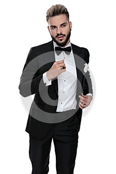 Businessman standing with hand folded and grabbing jacket cool