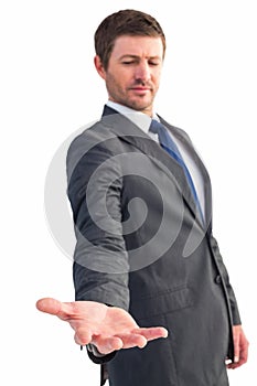 Businessman standing with hand out
