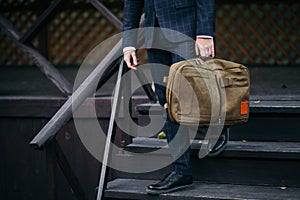 Businessman standing and holding a briefcase in hand working with confidence