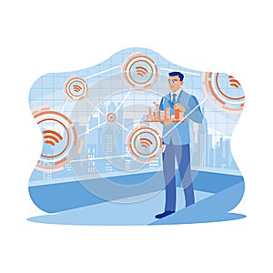 A businessman is standing holding a miniature city. Using modern creative networks and connected internet networks in smart.