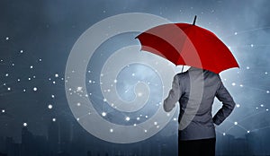 Businessman standing while holding and red umbrella over the networking connection