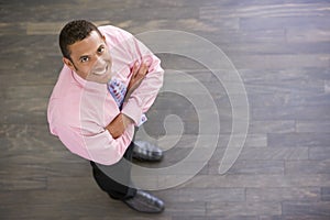 Businessman standing indoors smiling