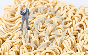 Businessman standing on the instant noodle