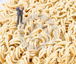 Businessman standing on the instant noodle