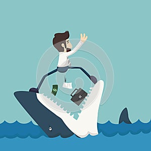 Businessman standing on Jaws of shark photo