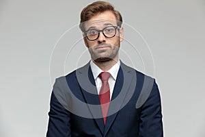 Businessman standing and looking at camera surprised