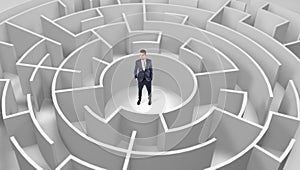 Businessman standing in a middle of a round maze