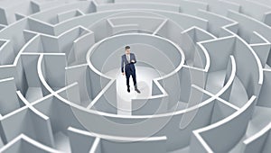 Businessman standing in a middle of a round maze