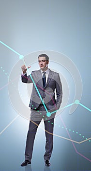 Businessman standing next to chart in business concept