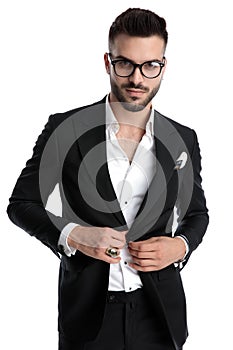 Businessman standing and opening his jacket happy