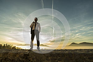 Businessman standing outdoors with his jacket over his shoulder