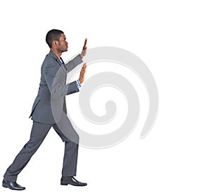Businessman standing and pushing with hands