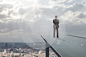 Businessman standing on road in sky