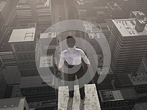 Businessman standing on the skyscraper top