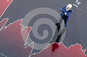 Businessman standing on the stock graph in tablet