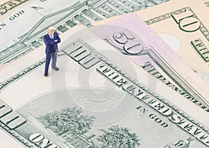 Businessman standing on the US dollar banknote