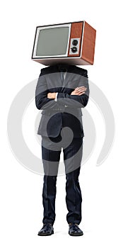A businessman stands with arms folded and a retro TV box instead of his head isolated on a white background.