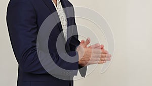 Businessman stands and gesticulation by hands.