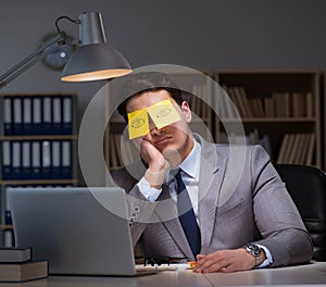 Businessman staying late to sort out priorities