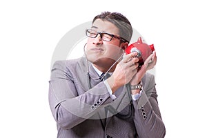 Businessman with stethoscope and piggybank isolated white backgr
