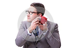 Businessman with stethoscope and piggybank isolated white backgr