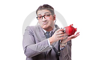 Businessman with stethoscope and piggybank isolated white backgr