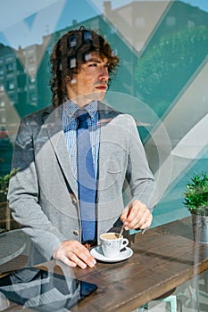 Businessman stirring coffee