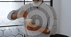 Businessman stirring coffee at office 4k