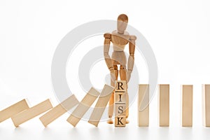 Businessman stop domino effect with word Risk
