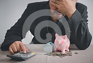 Businessman is stressed out of losing their jobs and insufficient savings to pay for a mortgage photo