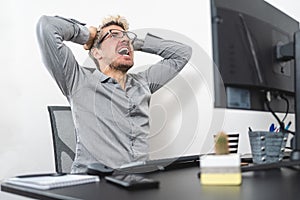 Businessman stressed out and screaming at the office. Stress at work concept
