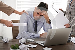 Businessman stressing out at workplace in office