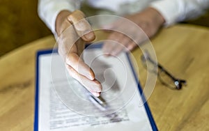 Businessman stretching his hand to shake, concluding contract concept