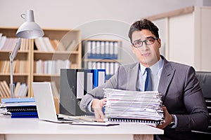 The businessman struggling with stacks of papers photo