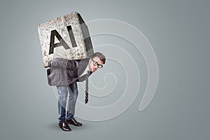 Businessman struggling under an AI-labeled stone on his back